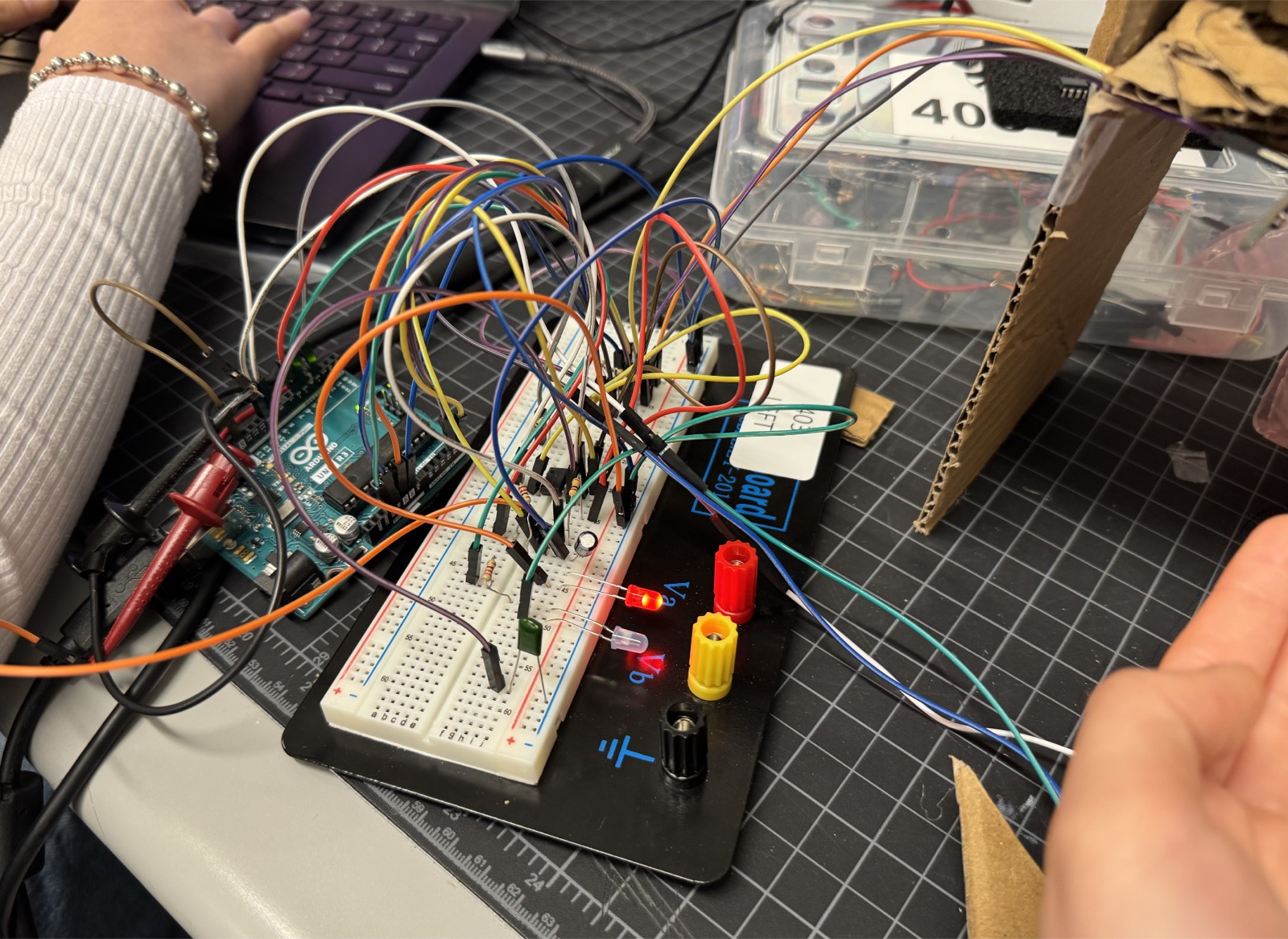 Close-up of the breadboard with the red and blue feedback LEDs lit.